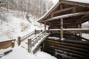 Wooden old-style structure with baptistery in Russian Orthodox Monastery at winter