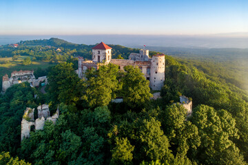 Ruins of medieval Tenczyn castle in Rudno near Krakow in Poland. Aerial view in sunrise light in summer - 755688634