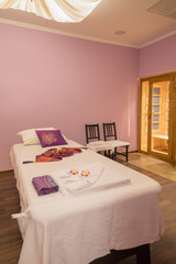 Empty light room with white bed for thai massage and asian decoration