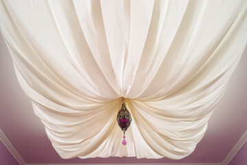 Big white canopy hanging from ceiling with ornate decoration in room