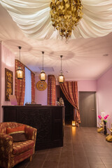 Wooden reception with carving in thai day spa with asian decoration and canopy