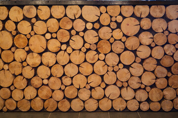 Logs of trees, pile of yellow round wood logs, this is decoration of bar counter