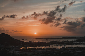 Orange and Blue Sky, Rocks, Mountains, and Sea Reflection