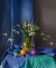 A still life arrangement of Easter eggs, spring flowers. Still life with snowdrops and ester eags. - 755693284