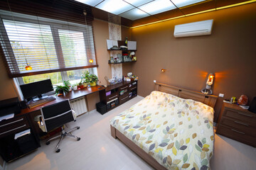 Cozy empty modern bedroom with bed with workplace and luminous ceiling, top view