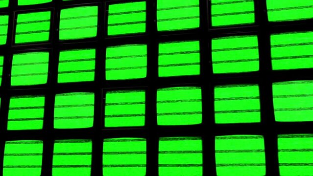 Grid Pattern of Black TV Monitors with Glitch Static Green Screen