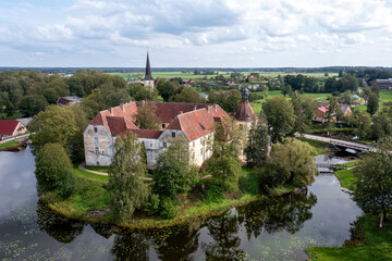 Fototapeta na wymiar Jaunpils castle was built in 1301. as Livonia Order fortress. Latvia, aerial drone view