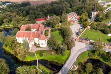 Fototapeta na wymiar Jaunpils castle was built in 1301. as Livonia Order fortress. Latvia, aerial drone view