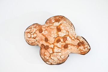Colomba pasquale or Easter Dove is a traditional Italian dessert prepared with sourdough, almonds and candied fruit top view on white background isolated