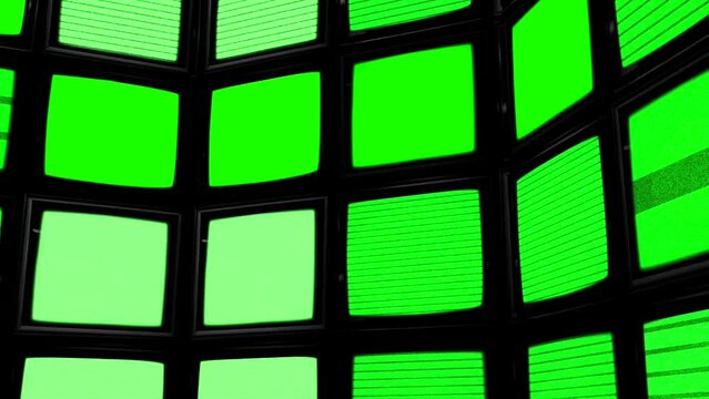 A Curved Array of Screens Displaying Green Screen Static in the Dark. Chroma Key