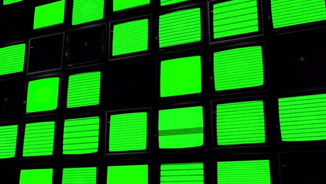 A large wall of green screen TV monitors. Key out the green to add your own media. Chroma Key
