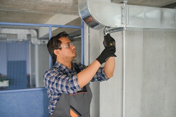 Ventilation cleaning. Specialist at work. Repair ventilation system (HVAC). Industrial background