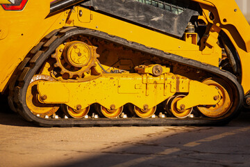 Industrial compact skid steer loader rubber tracks close up of construction equipment