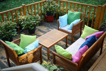 Empty cozy terrace with couch, table, chairs with pillows for resting