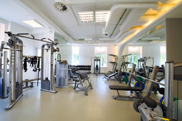 Fototapeta na wymiar Empty modern gym with fitness equipment, mirror for sport training