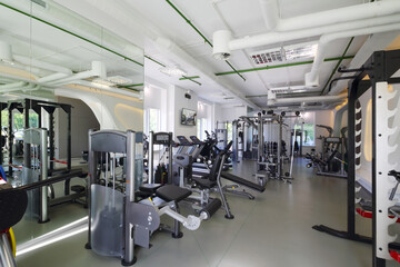 Fototapeta na wymiar Empty modern gym with new shiny fitness equipment for sport training