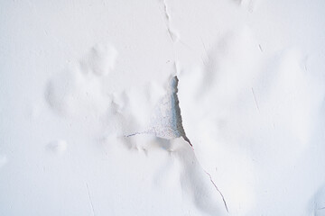 Cracked white paint on the ceiling close-up