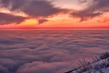 Endless sea of clouds in the highlands at sunset; concept of romantic unforgettable moments