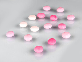pink and white pills on white