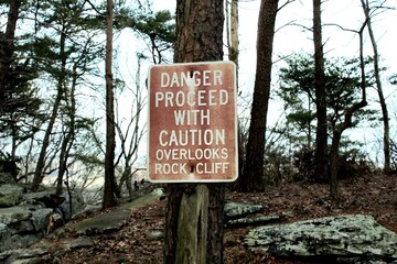 Sign alerting hikers of rock fall danger.