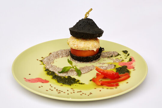Ground-meat cutlet with vegetables and sauce on plate