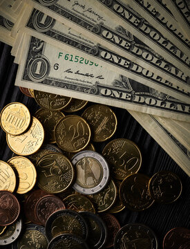 Money background with euro cents and one dollar bills over black wooden background
