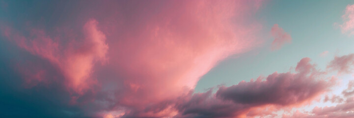 A Colorful Cloudy Sky With Pink And Blue Hues at Sunset