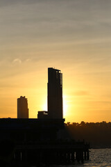 Silhouette picture of Tall buildings and mountains in the evening sun is about to set.