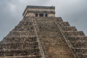 Sunny day with blue sky and white clouds. El Castillo (The Kukulkan Temple) of Chichen Itza, mayan pyramid in Yucatan, Mexico
