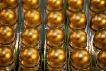 golden background, sweet in a box, golden sweet balls, golden brigadeiro, party sweet, close up of sweet, glitter sweetie, gold chocolate 
