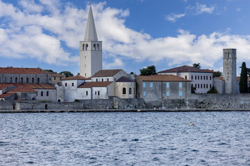 View from Nikole Tesle street of seaside with bell tower of Euphrasian Basilica, Porec, Croatia,...