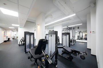 Fototapeta na wymiar Empty modern and light fitness center with many sport equipment