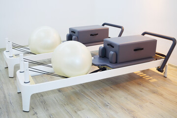 Wooden trainers with fitballs for pilates - gym equipment in fitness center