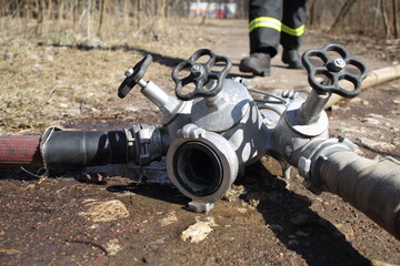 Faucet from firefighter hose on the ground in a park