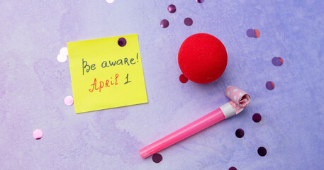Concept of Happy 1 april Fools day. Image of letter Be aware and festive decor