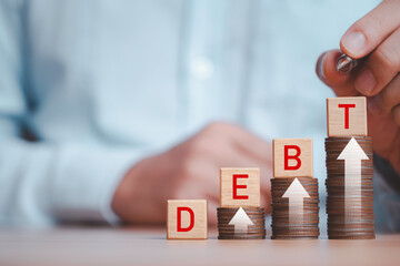 Debt wording on cube with Increasing coins stack and up arrow for debt include home loan , consumer...