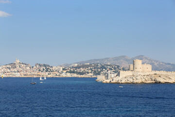 Fototapeta na wymiar Boats sail near Chateau IF fortress on island and coastal city at summer, Marseille, France