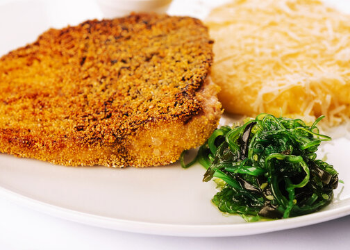 Fried sea fish steak with chuka seaweed salad