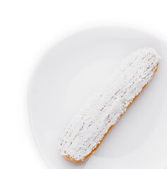 eclair in white glaze and coconut flakes