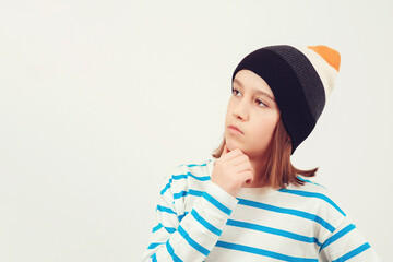 Cute boy thinking over white background. Thoughtful clever schooler. Student with serious expression.