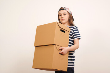 Young smiling boy holding the box on white background. Child with carton package. Delivery Concept.