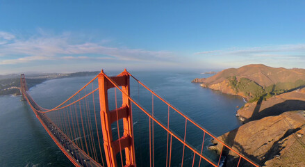  San Francisco Bay and transport traffic on Golden Gate bridge at autumn sunny day. Aerial view....