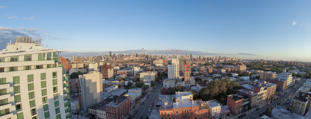 Cityscape with Dutch Kills district, Queensboro Bridge and Manhattan skyscrapers at summer evening. Aerial panorama