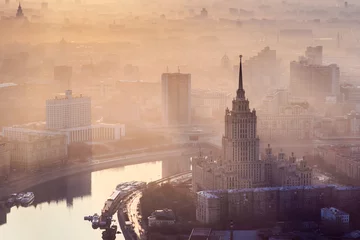 Fototapeten Sunrise in the foggy day over Moscow. Hotel Ukraine, Moskva river, building of Russian Government © Pavel Losevsky