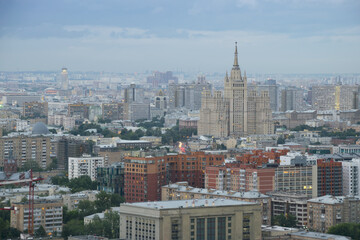 Fototapeta premium Residential building on square Kudrinskaya (Stalin skyscraper) at overcast evening in Moscow, Russia