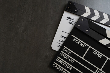 movie clapper on black table background ; film, cinema and video photography concept