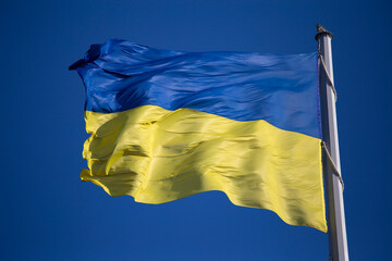 National flag of Ukraine against blue sky