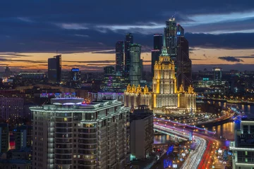 Tuinposter  Hotel Ukraine, Moskva river and Moscow City business complex at night in Moscow, Russia © Pavel Losevsky