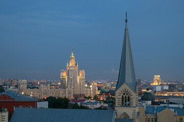 Evangelical Lutheran Church of St. Peter and St. Paul and Stalinist skyscraper on Kotelnicheskaya Quay in night in Moscow