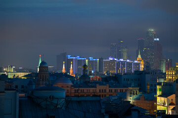 Fototapeta na wymiar Stars on Kremlin towers, skyscrapers and buildings of New Arbat Street in center of Moscow, Russia at night